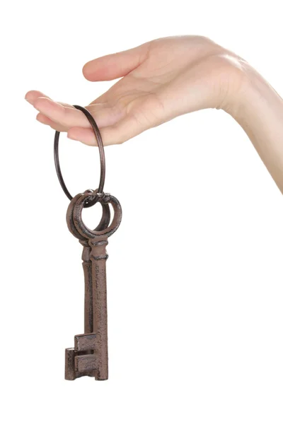 Woman's hand holding a bunch of antique keys on white background — Stock Photo, Image
