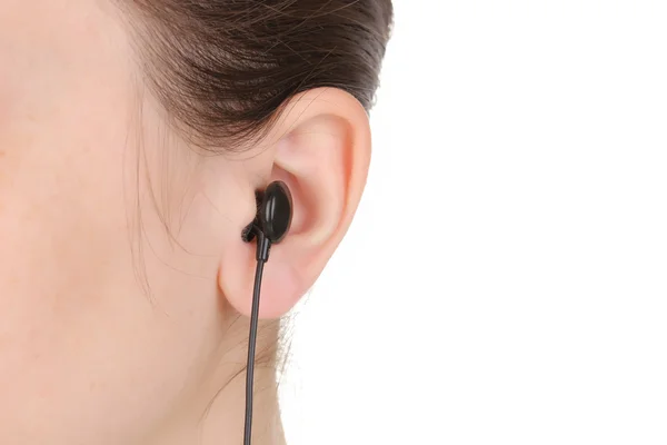 Menselijk oor met oortelefoon close-up geïsoleerd op wit — Stockfoto
