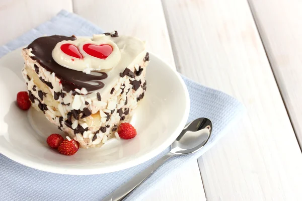 stock image Sweet cake with chocolate on plate on wooden table