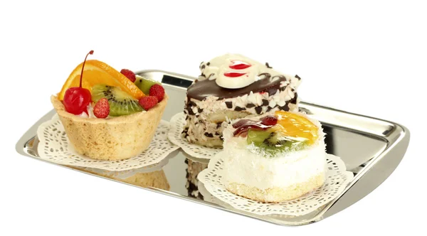 Tortas dulces con frutas y chocolate en bandeja de plata aislada en blanco —  Fotos de Stock