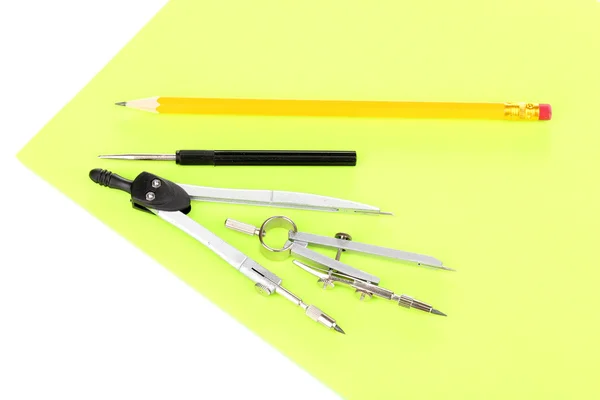 Drafting instruments on color paper isolated on white — Stock Photo, Image