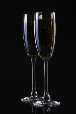 Two glasses of champagne on black background clipart