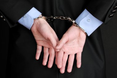 Businessman hands fettered with handcuffs clipart