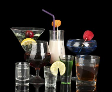 A variety of alcoholic drinks isolated on black clipart