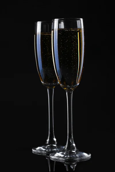 Two glasses of champagne on black background — Stock Photo, Image