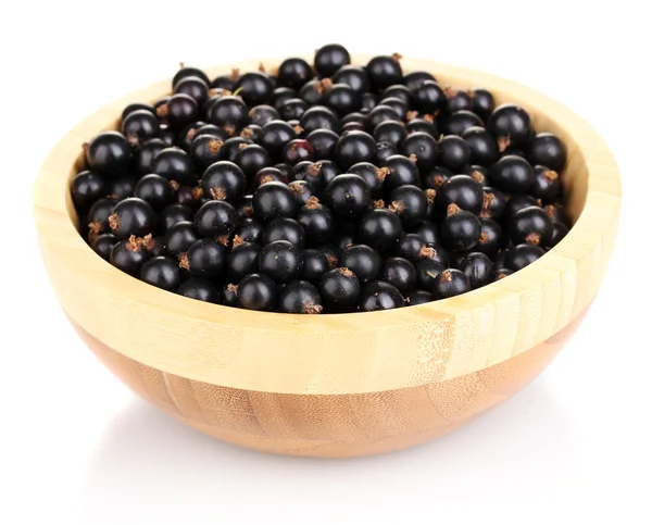 Black currant in wooden bowl isolated on white — Stock Photo, Image