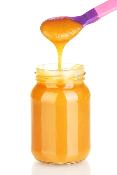 Jar with baby food and spoon on white background close-up — Stock Photo, Image