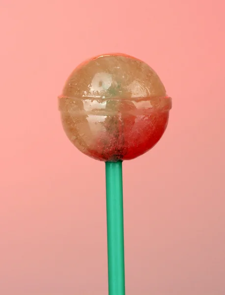 Sweet and tasty lollipop on pink background close-up — Stock Photo, Image