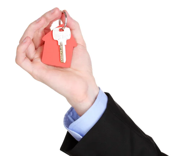 Key with house-shaped charm in hand isolated on white — Stock Photo, Image