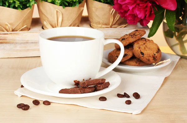 Φλιτζάνι καφέ, μπισκότα, σοκολάτα και λουλούδια στο τραπέζι στο café — Φωτογραφία Αρχείου