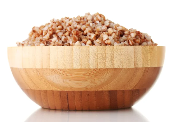 Boiled buckwheat in a wooden bowl isolated on white — Stock Photo, Image
