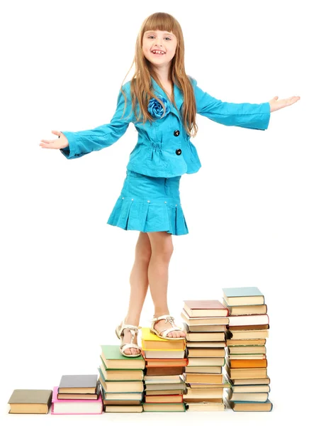 Liten flicka med en böcker isolerad på vit — Stockfoto