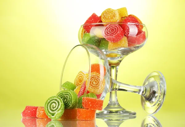 Colorful jelly candies in in cocktail glasses on green background — Stock Photo, Image
