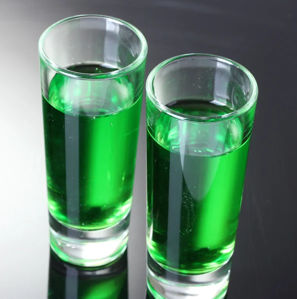 Two glasses of absinthe on grey background — Stock Photo, Image