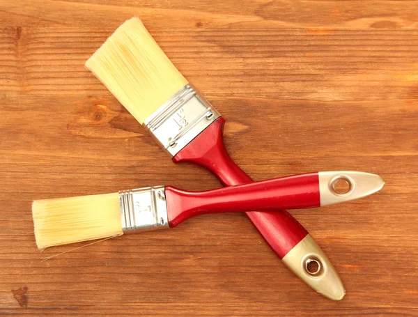Paint brushes on wooden background — Stock Photo, Image