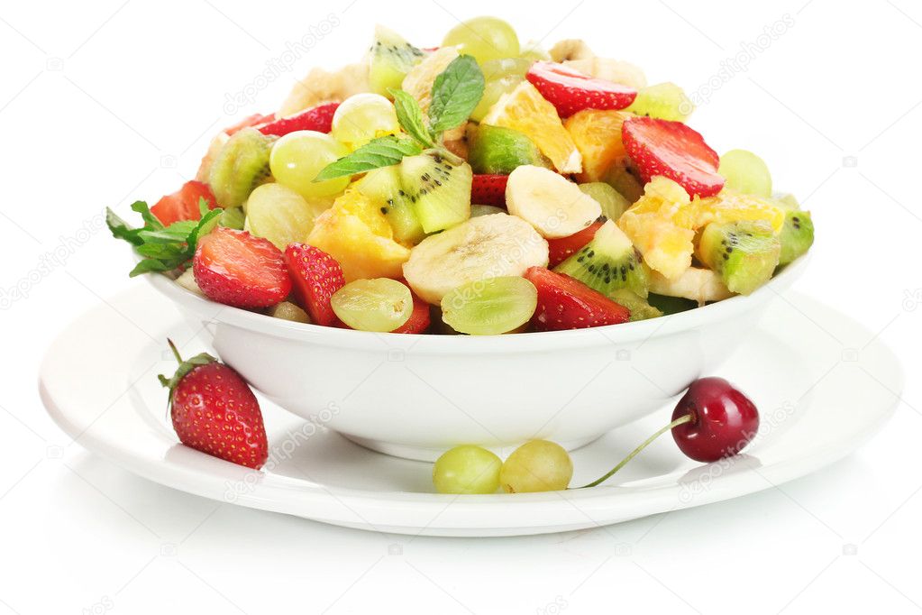 Bowl with fresh fruits salad and berries isolated on white