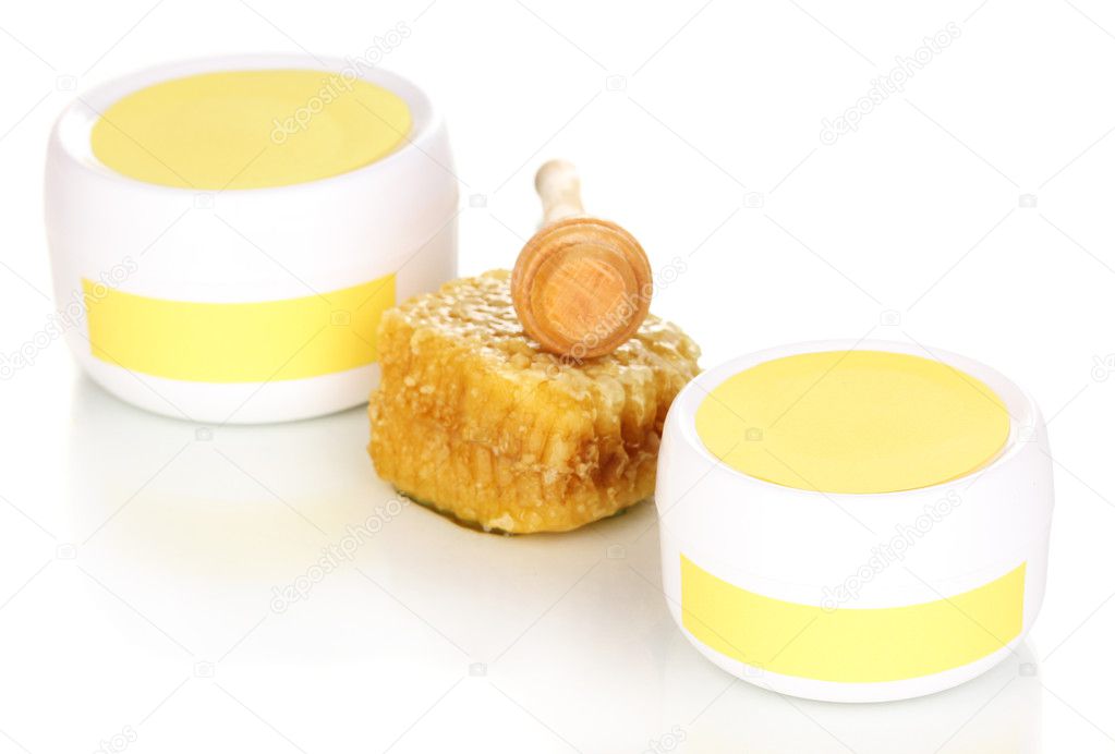 Jars of cream with honey isolated on white