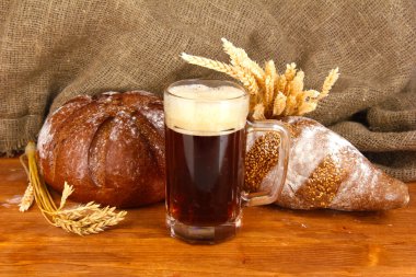 Glass of kvass with bread on canvas background close-up clipart