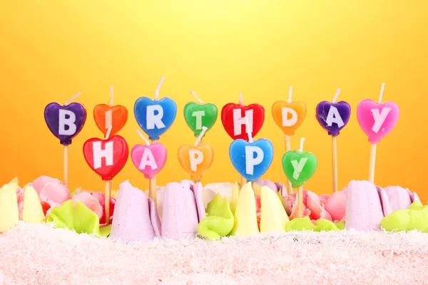 Verjaardagscake met kaarsen op gele achtergrond — Stockfoto