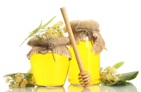 Jars with linden honey and flowers isolated on white — Stock Photo, Image