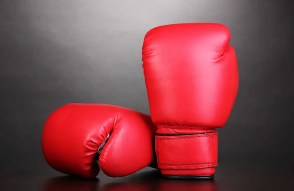 Red boxing gloves on grey background — Stock Photo, Image