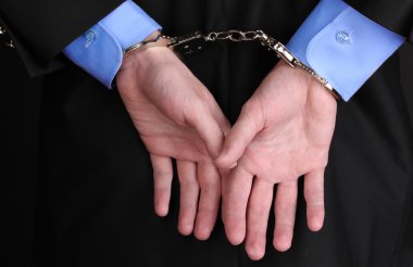 Businessman hands fettered with handcuffs clipart