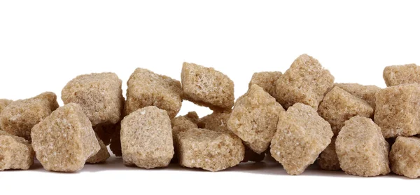 Lump brown cane sugar cubes isolated on white — Stock Photo, Image