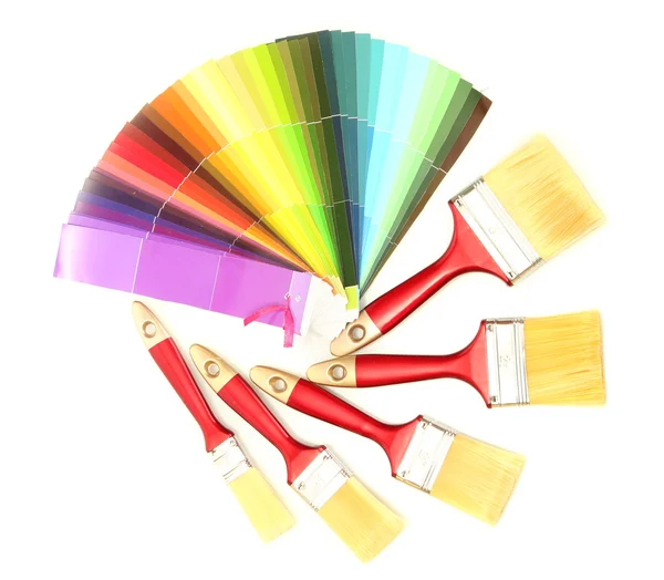 Paint brushes and bright palette of colors isolated on white — Stock Photo, Image