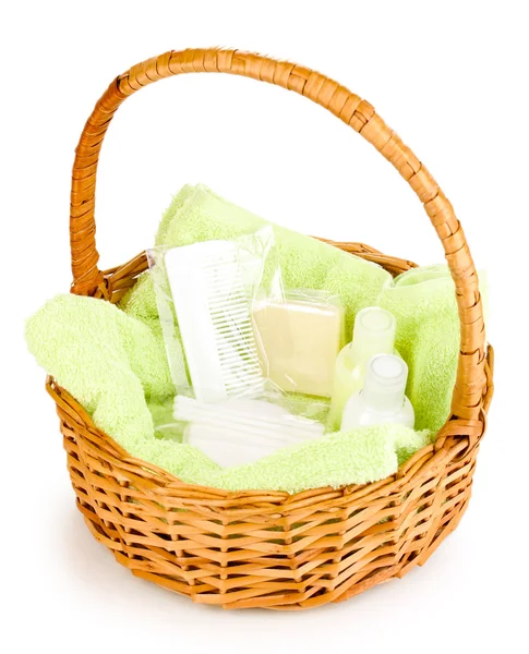 Hotel amenities kit in basket isolated on white — Stock Photo, Image