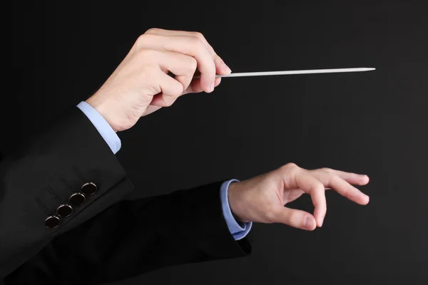 Music conductor hands with baton isolated on black — Stock Photo, Image