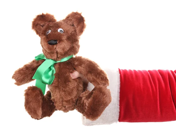 Santa claus ruka drží hračka medvěd izolované na bílém — Stock fotografie