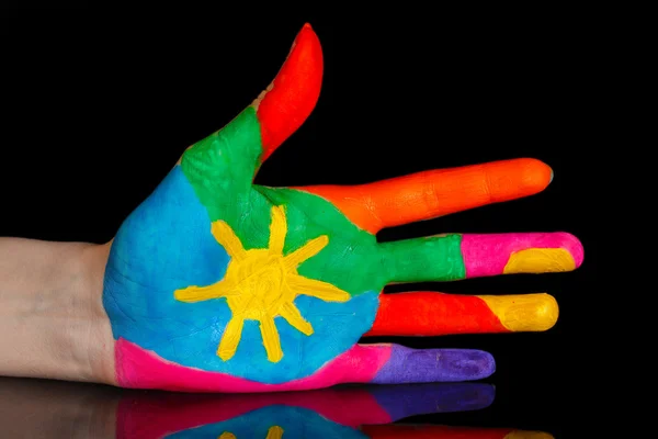 Brightly colored hand on black background close-up — Stock Photo, Image