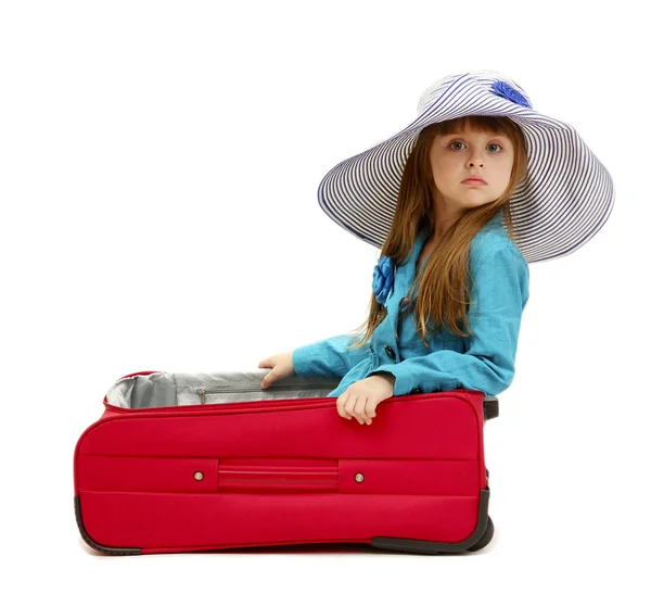 Portrait of little girl in travel case with hat isolated on white — Stock Photo, Image