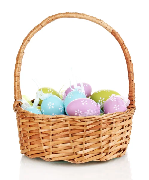 Colorful easter eggs in basket isolated on white — Stock Photo, Image