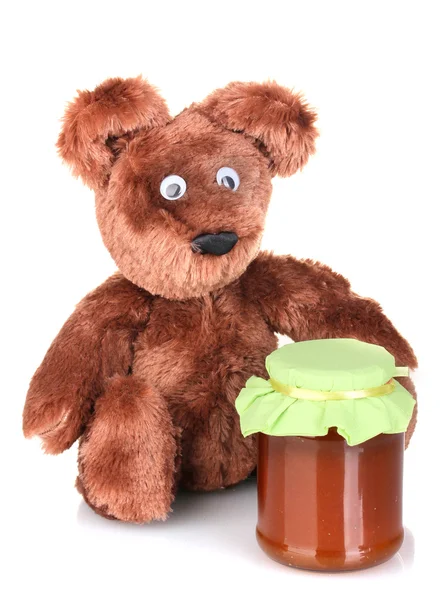 Bärenspielzeug und süße Marmelade isoliert auf weiß — Stockfoto