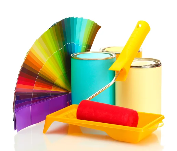 Tin cans with paint, roller, brushes and bright palette of colors isolated on white Stock Photo