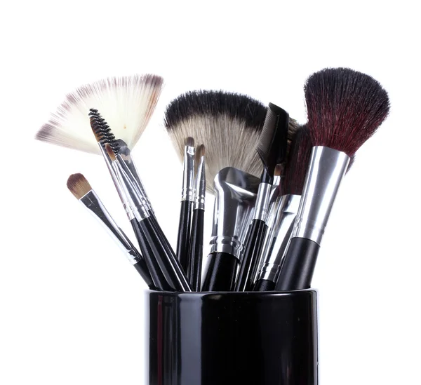 Make-up borstels in zwarte kop geïsoleerd op wit — Stockfoto