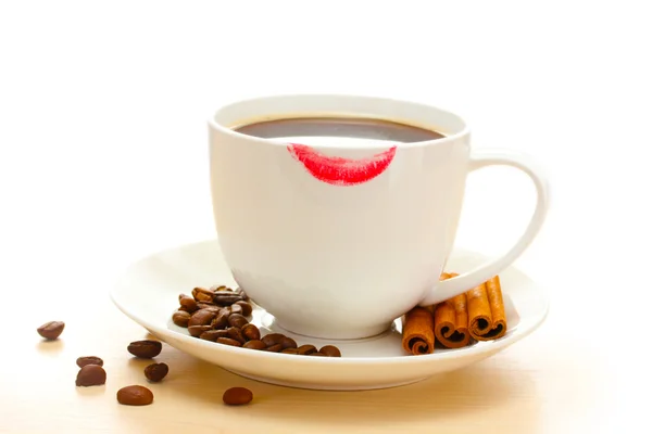 Cup of coffee with lipstick mark beans and cinnamon sticks isolated on white — Stock Photo, Image