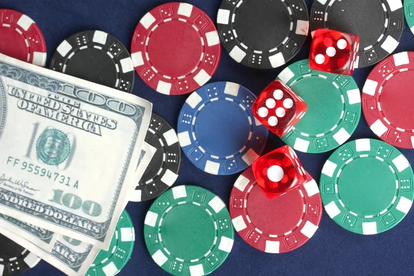Frame made of poker chips, playing cards and dollars on the blue background close-up — Stock Photo, Image