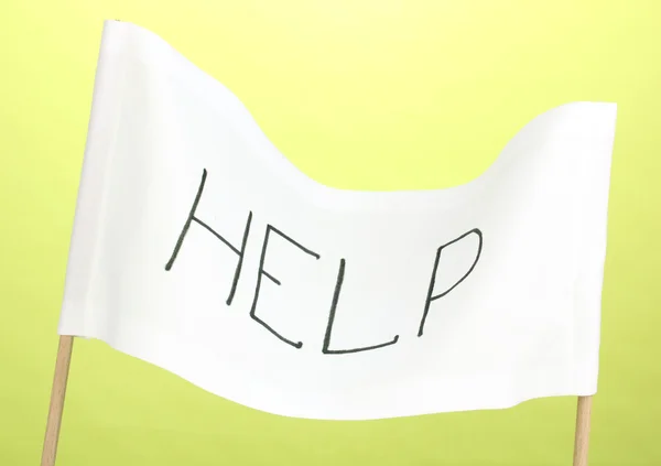 Yeşil zemin üzerine beyaz bir bez üzerinde yazılı yardım — Stok fotoğraf