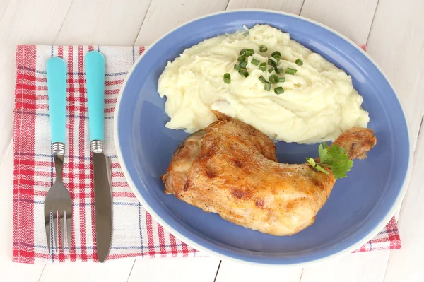Cuisse de poulet rôtie avec purée de pommes de terre dans l'assiette sur table en bois blanc close-up — Photo