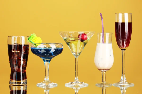 Uma variedade de bebidas alcoólicas sobre fundo amarelo — Fotografia de Stock