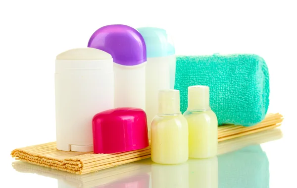 Bouteilles de déodorant et de cosmétiques avec serviette isolée sur blanc — Photo