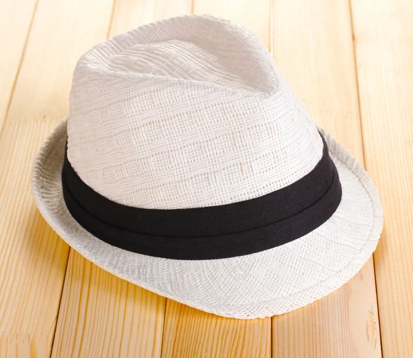 Beautiful white hat on wooden background — Stock Photo, Image