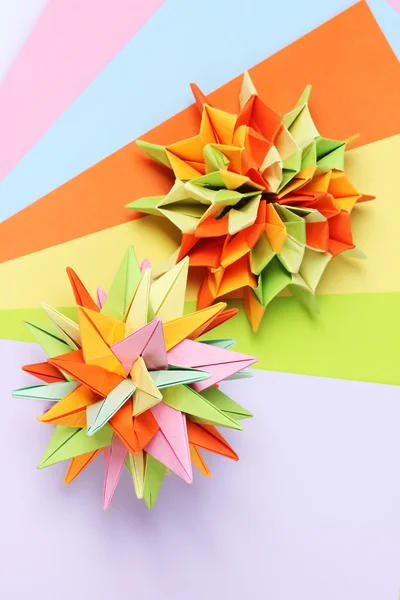 stock image Colorfull origami kusudamas on bright paper background