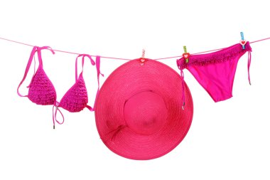 Women's swimsuit and hat hanging on a rope on white background clipart