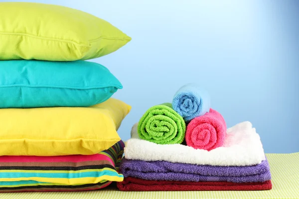 Pillows and towels on blue background — Stock Photo, Image