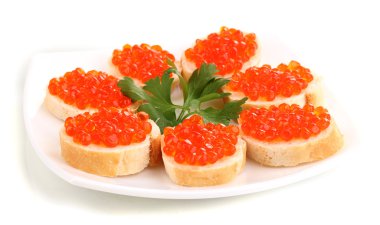 Red caviar on bread on white plate isolated on white clipart