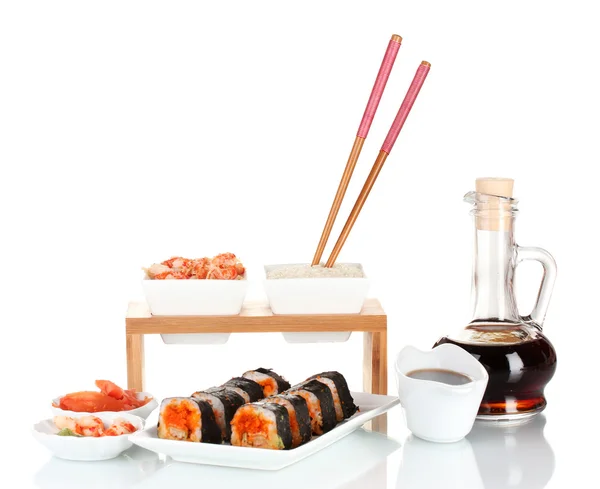 Delicious sushi on plate, chopsticks, soy sauce, fish and shrimps isolated on white — Stock Photo, Image