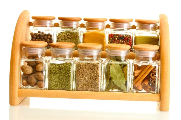 Powder spices in glass jars on wooden shelf isolated on white — Stock Photo, Image
